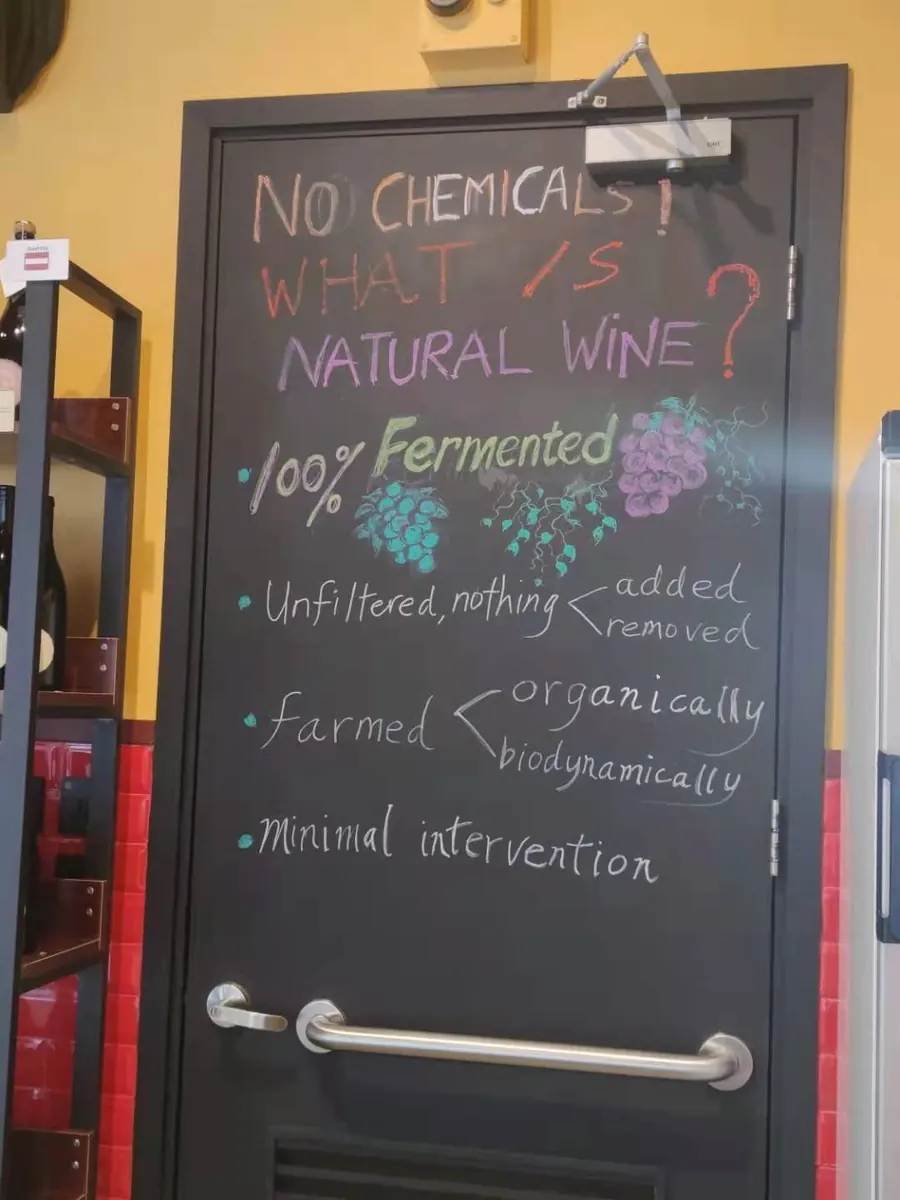 A chalkboard in the shop asking: No chemicals? What is natural wine?