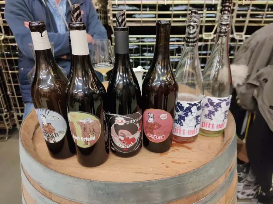 Pittnauer bottles lined up on a barrel
