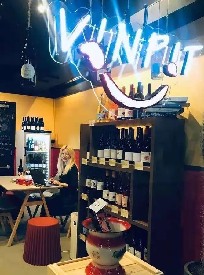 Vinpit's neon logo glowing above the shop counter