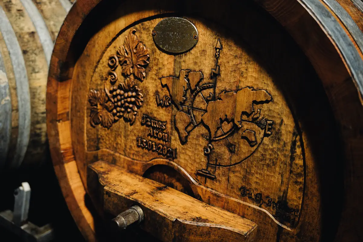 A carved wooden barrel head in the cellar