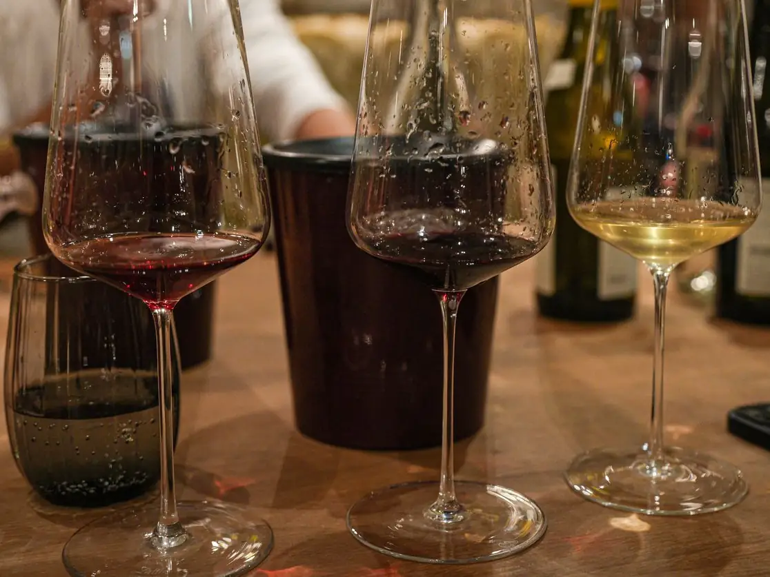 Glasses of red and white wine on a wooden table